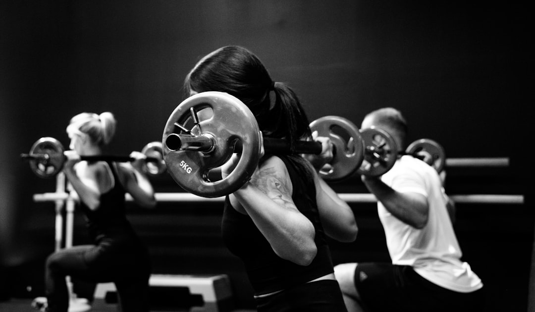 Zwei Athleten in einem dynamischen Fitnessstudio in Aktion, symbolisierend Stärke und Fokus.